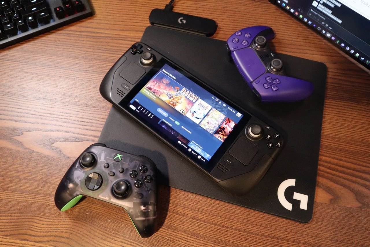 Steam Deck surrounded by an Xbox and PS5 DualSense controller